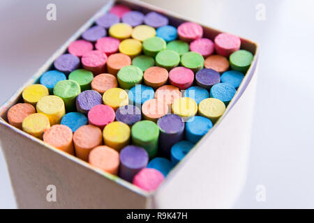 Colorful chalk in a cardboard box, Box of chalk on white background Stock Photo