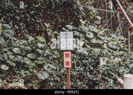 Sign along the stair up to Awashima Shrine on Awashima Island in Numazu, Japan. Translation - the sign saying "Work Hard" Stock Photo
