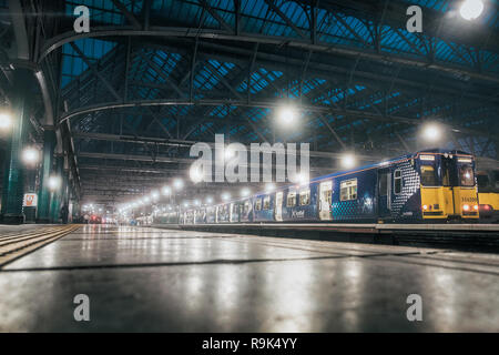 Glasgow central railway station. View from the lowest point on the station building and the train. Cold weather. Historic railway station and perspect Stock Photo
