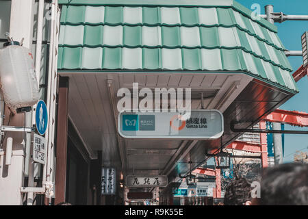 Sign showing the way to a Tokyo Metro station on Ginza line in front of Asakusa temple over the sidewalk Stock Photo