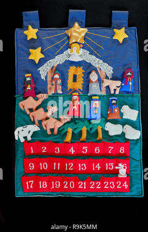 Traditional christian advent calendar leading up to christmas day with figures of Jesus, Mary and Joseph, shepherds and sheep, kings and gifts, an ang Stock Photo