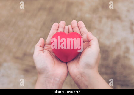Red heart ball : Stress reliever foam ball the red heart shape on woman hand. Gift valentine's Day Stock Photo