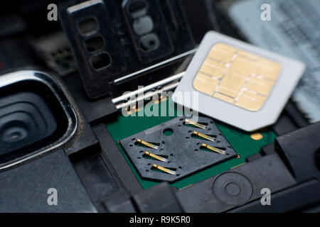 Sim card slot / socket in mobile smart phone close up. Stock Photo