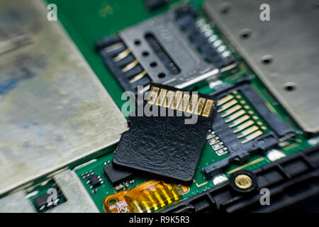 Micro sd card slot inside electronic circuit board smart phone. disassembled cell phone parts. Stock Photo