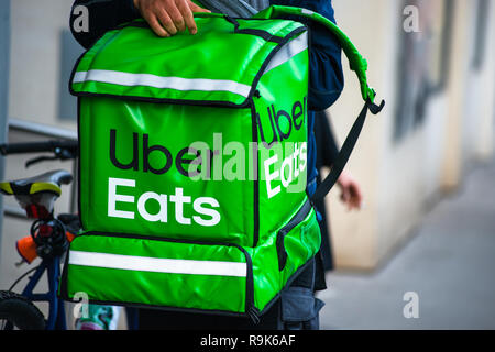 Uber Eats is an American online food ordering and delivery service. Delivery in progress on Vienna street. Austria. Stock Photo