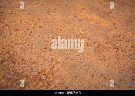 Brown rust stains texture of the old white paint on rusty metal wall. Rusty metal background. Stock Photo