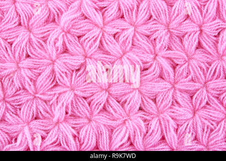 Pink woolen texture background. Macro of knitted cloth. Stock Photo