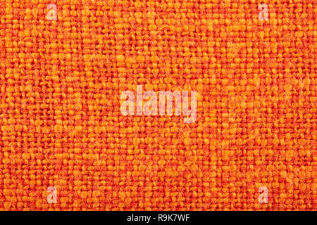 Orange crumpled burlap texture background. Macro of hessian cloth. Stock Photo