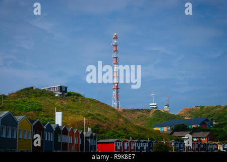A radio tower on the hills in front of the Hummerbuden of Helgoland Germany in the north sea. Stock Photo