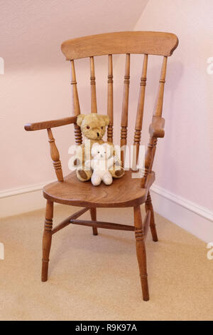 Teddy bear antique victorian soft toy on wooden chair Stock Photo