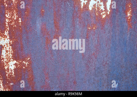 Old metal shield is painted gray paint with rust and cracks. Stock Photo
