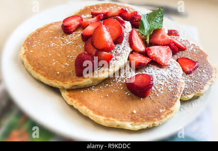 Pancakes. Sweet honey pouring over pancakes. Tasty breakfast food. Stock Photo