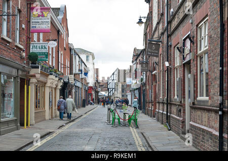 York, England - April 2018: Old brick buildings housing shops and restaurants along Swinegate Street in historic district of City of York, England, UK Stock Photo