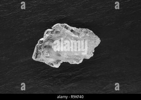 Sugar or salt crystal placed on black stone background surface Stock Photo