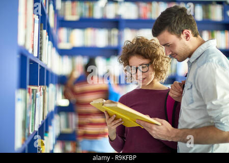 Young students reading book together Stock Photo