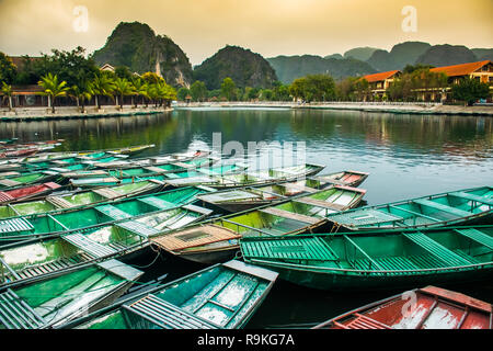 Amazing morning view with Vietnamese boats at river, Tam Coc, Ninh Binh in Vietnam travel landscape and destinations Stock Photo