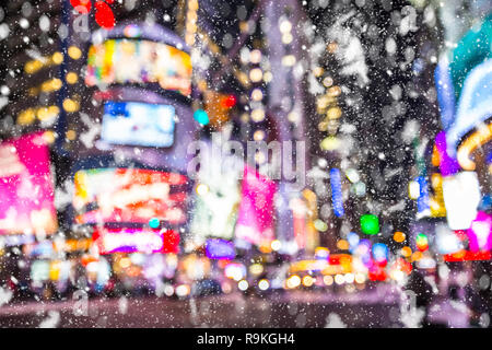 Defocused blur Times Square  New York City  Manhattan street scene with cars , lights and snowflakes falling during winter snow storm Stock Photo