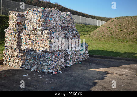 Modern waste sorting and recycling plant. Bales of dairy and drink bottles garbage in recycling plant yard prepared for shipment and reuse. Concept of Stock Photo