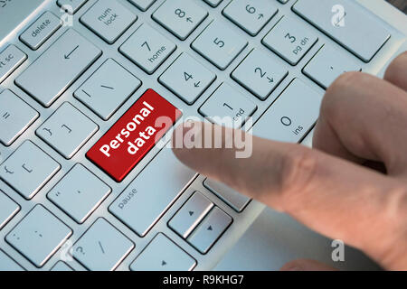 Closed up finger on keyboard with word PERSONAL DATA, Red button. inscriptions on the grey silver keyboard button close up Stock Photo