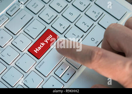 Finger going to presses the key hack you on a English language and red light keyboard for hacker, hacker works on the keyboard. danger. Protection and Stock Photo