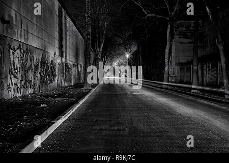 dark and empty city street with car light trails Stock Photo