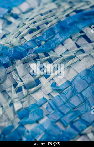Macro-photo of very worn blue cheap Poly-Tarpaulin - exposed inner woven plastic fabric laminated with blue LDPE / Low-density Polyethylene. Stock Photo