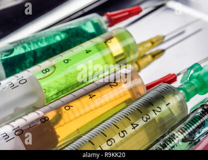 Syringes of different size, conceptual image Stock Photo