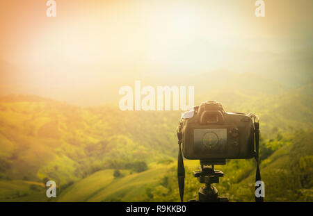 Digital camera professional / camera on tripod with view of mountain nature on background - Take photos Shooting nature Stock Photo