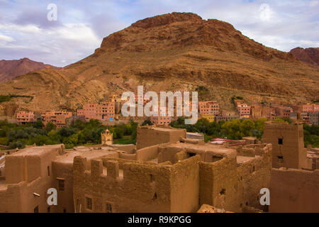 The ancient moroccan town near Tinghir with old kasbahs and high Atlas mountains in background, Tinghir, Morocco in Africa Stock Photo