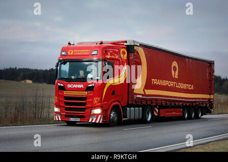 Salo, Finland - December 14, 2018: Red Next Generation Scania S500 semi trailer of Translog drives along highway in Finland on a cloudy day. Stock Photo