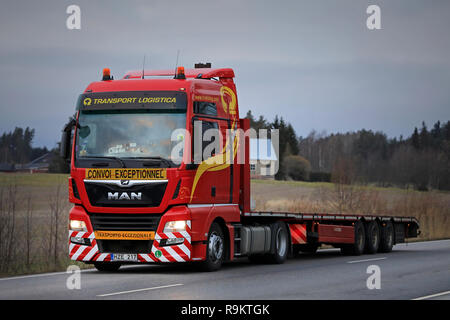 Salo, Finland - December 14, 2018: New red MAN TGX semi trailer truck of Translog for special transport on the road in Finland on a cloudy evening. Stock Photo