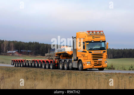 Salo, Finland - December 14, 2018: Yellow Scania semi in front of multi axle trailer for heavy transport of Nostokonepalvelu on the road in Finland. Stock Photo