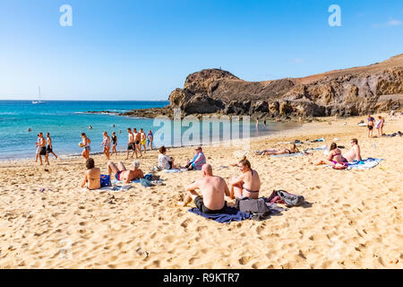LANZAROTE, SPAIN - DEC 14, 2018: People relaxing on Papagayo beach on