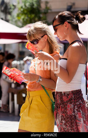 Tourists consulting guidebook. Tourist information. . Malaga Spain .female tourist in spain Stock Photo