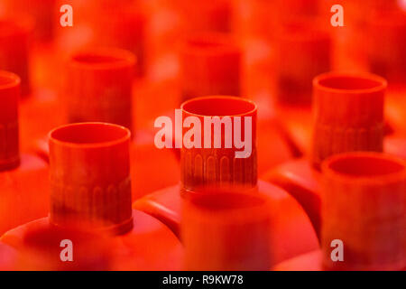 Red plastic tops on plastic bottles Stock Photo