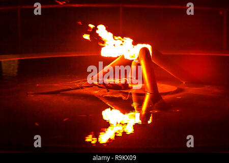 Close-up of eternal flame by night in Kings Park, Perth city, Western Australia. The flame of remembrance in the fountain, State War Memorial. Stock Photo