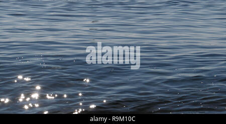 Close up of sparkling surface of sea with small waves Stock Photo