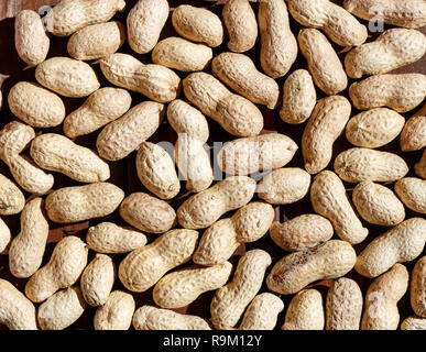 Peanuts in shell texture food background top view. Hard light Stock Photo
