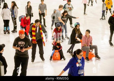 Wearing wizard robes and Gryffindor scarves, Harry Potter book devotees participate in an ice skating event in honor of author J.K. Rowling in Anaheim, CA. Stock Photo