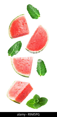 Flying fresh watermelon slices and mint leaves isolated on white background with clipping path as package design element and advertising. Full depth o Stock Photo