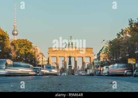 Back side of the Brandenburg Gate from the ground perspective with road traffic in the long exposure. TV tower next to the Brandenburg Gate at autumn Stock Photo