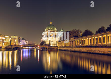 Berlin Cathedral at night with the Friedrichs Bridge. On the river Spree reflect the lights. The illuminated pillar gallery on the Spree shore Stock Photo