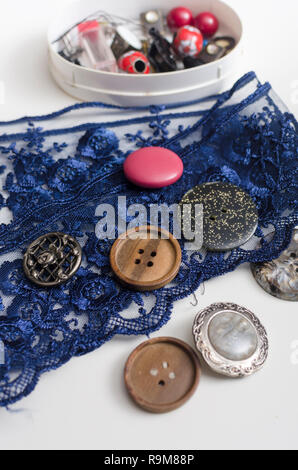 Tools and accessories for sewing on light wooden background. Stock Photo