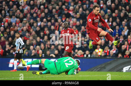 Newcastle United goalkeeper Martin Dubravka (left) collects the ball from Xherdan Shaqiri (right) during the Premier League match at Anfield, Liverpool. Stock Photo