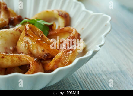 Adobong Pusit , Squid Adobo, Filipino cuisine, Traditional assorted dishes, Top view. Stock Photo