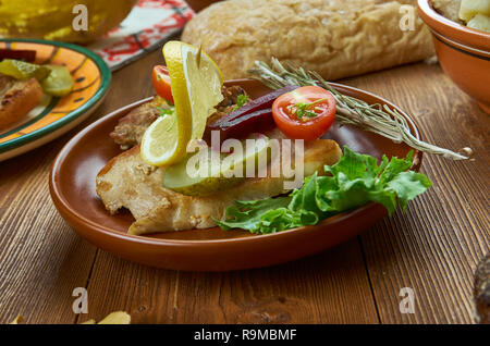 Smorrebrod med faeskesteg,Pork loin sandwich with pickled cucumbers and vegetables,  Danish homemade cuisine, Traditional assorted dishes, Top view. Stock Photo