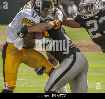 Oakland, California, USA. 23rd Sep, 2012. Oakland Raiders strong safety Tyvon Branch (33) tackles Pittsburgh Steelers wide receiver Mike Wallace (17) on Sunday, September 23, 2012, in Oakland, California. The Raiders defeated the Steelers 34-31. Credit: Al Golub/ZUMA Wire/Alamy Live News Stock Photo