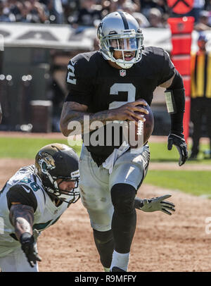 Oakland, California, USA. 15th Sep, 2013. Oakland Raiders quarterback Terrelle Pryor (2) runs out of pocket to avoid Jacksonville Jaguars defensive end Jason Babin (58) on Sunday, September 15, 2013, in Oakland, California. The Raiders defeated the Jaguars 34-31. Credit: Al Golub/ZUMA Wire/Alamy Live News Stock Photo