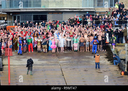 West Bay, Dorset, UK. 26th Dec, 2018. West Bay in Dorset.26th of December 2018.Swimmers are standing by the water before the West Bay boxing day swim Credit: Tom Meaker/Alamy Live News Stock Photo