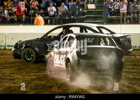 Cars head for a crash in a night time demo derby for police officer drivers at a Costa Mesa, CA, stadium. Stock Photo